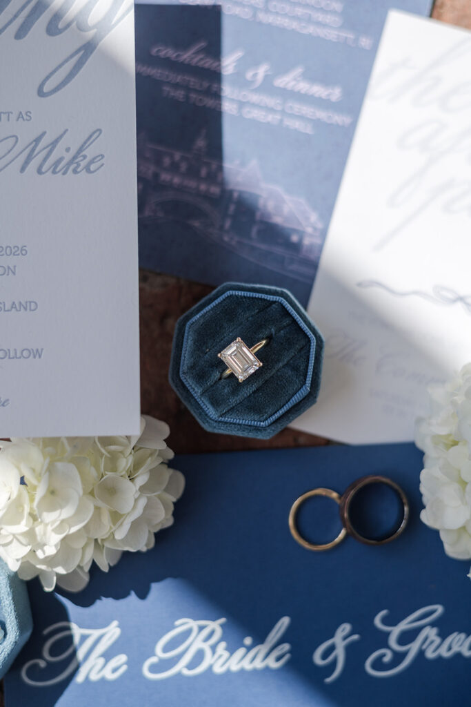 Blue and white custom wedding stationery styled with hydrangeas and a blue velvet ring box