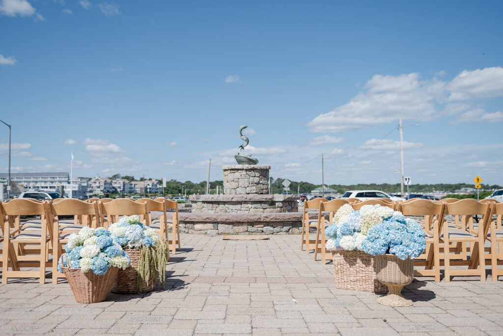 Coastal Rhode Island Wedding in a courtyard with hydrangea baskets and florals
