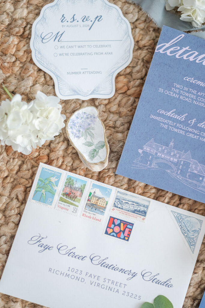 Full custom coastal wedding stationery suite with venue illustrations, shell RSVP and blue envelopes